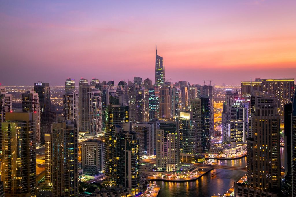aerial-view-of-city-lit-up-at-night-325193 Captivating view of Dubais skyline at dusk with vibrant city lights and skyscrapers.
