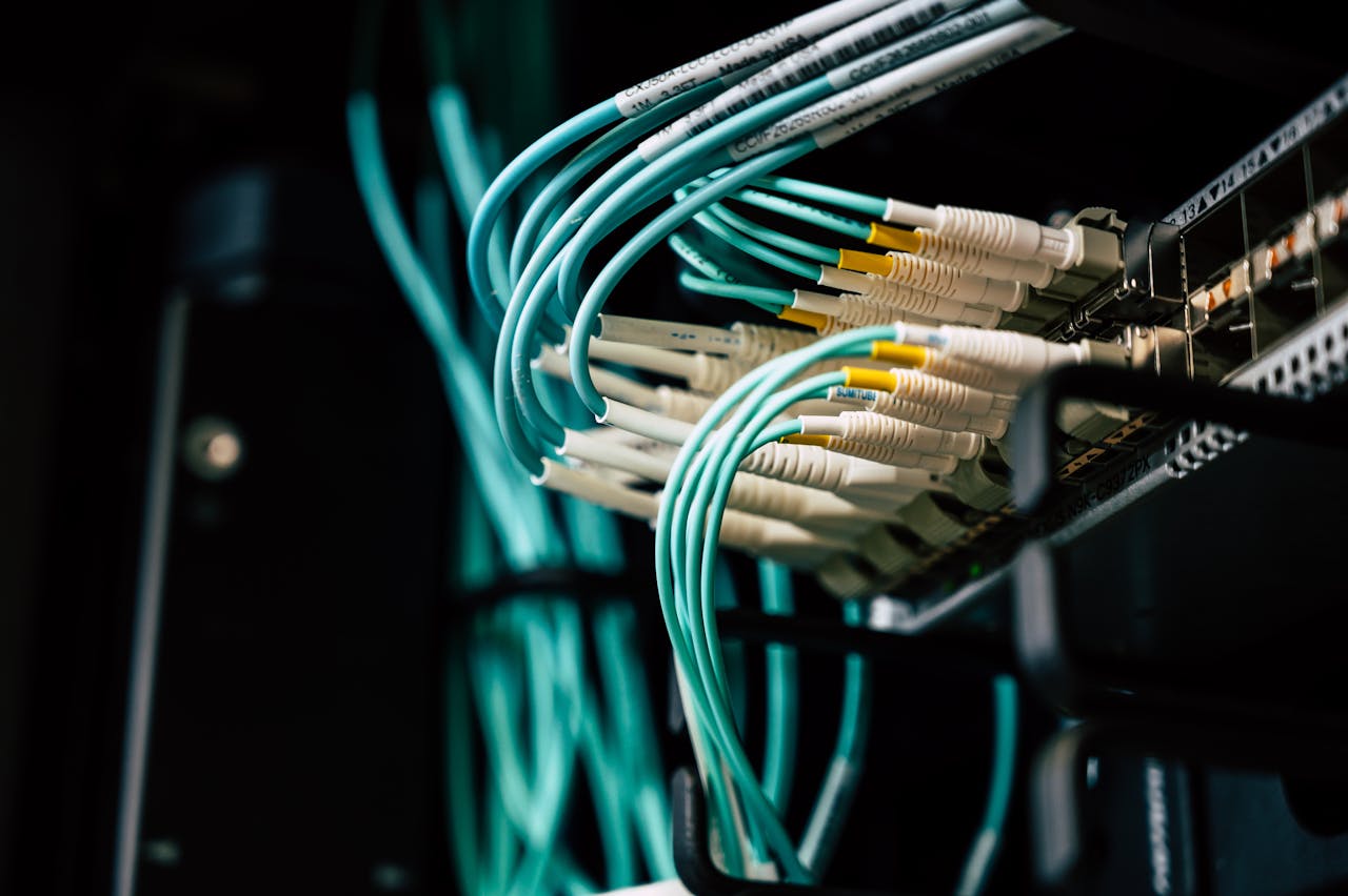 about-04 Detailed view of network cables plugged into a server rack in a data center.