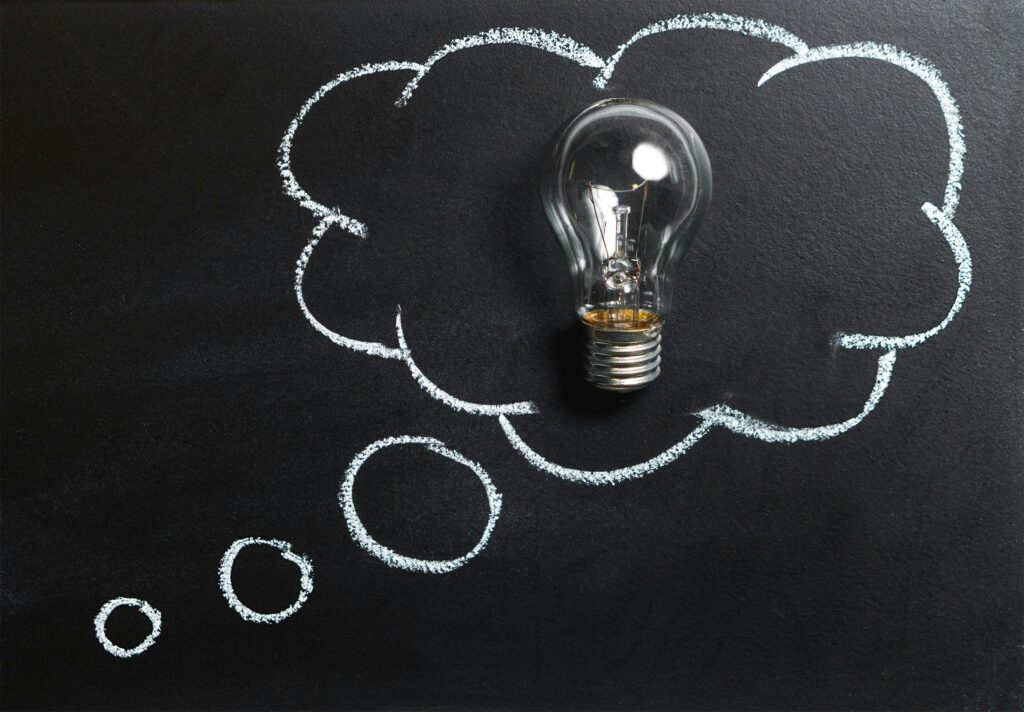 pexels photo 355952 355952 Light bulb laying on chalkboard with drawn thought bubble, symbolizing creative ideas.