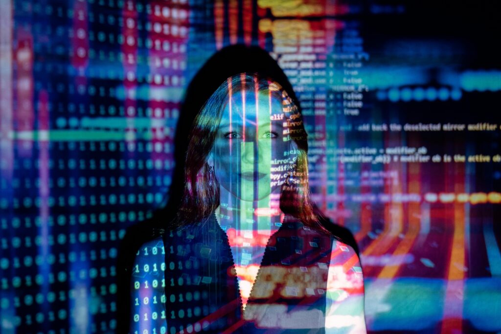 pexels photo 3861969 3861969 A woman with digital code projections on her face, representing technology and future concepts.